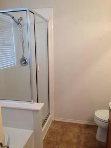 a bathroom with a shower and a toilet