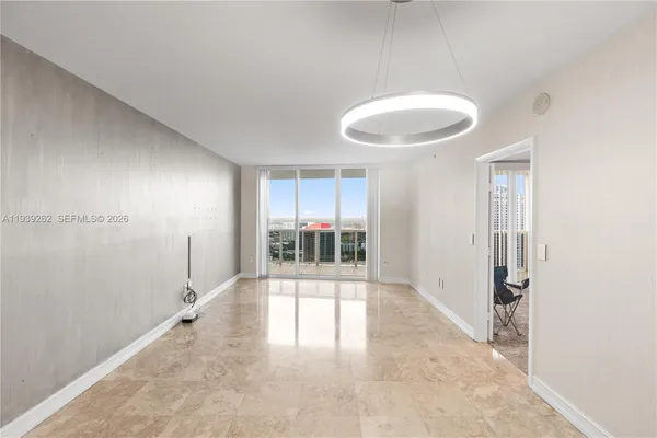 a view of kitchen with kitchen island stainless steel appliances a sink and cabinets