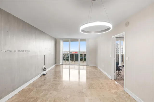 a view of a room with a large window and chandelier