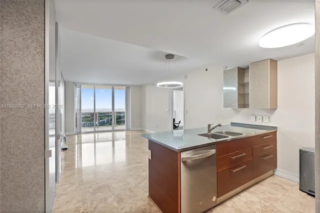 a kitchen with stainless steel appliances granite countertop a stove and a sink