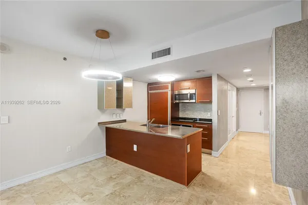 a kitchen with stainless steel appliances granite countertop a sink and a microwave