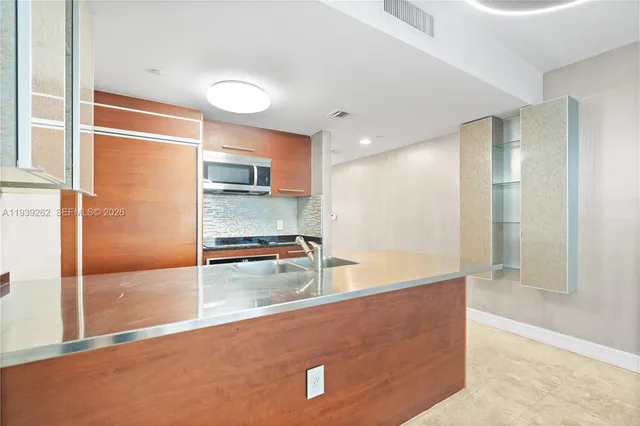 an empty room with closet and mirror