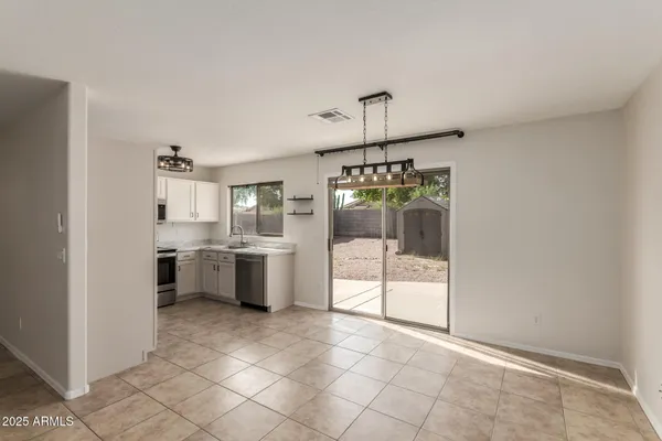 a open kitchen with a sink and refrigerator