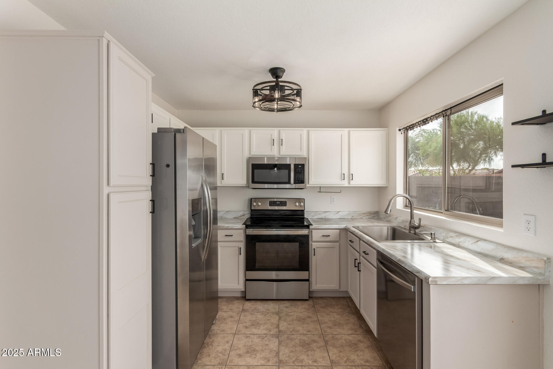 6932 South Russet Sky Way Gold Canyon, AZ 85118 - Photo 14 of 36 a kitchen with granite countertop a sink stainless steel appliances and window