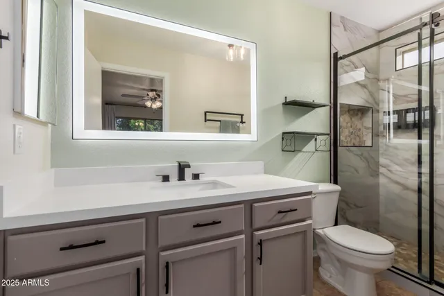 a bathroom with a toilet and a shower