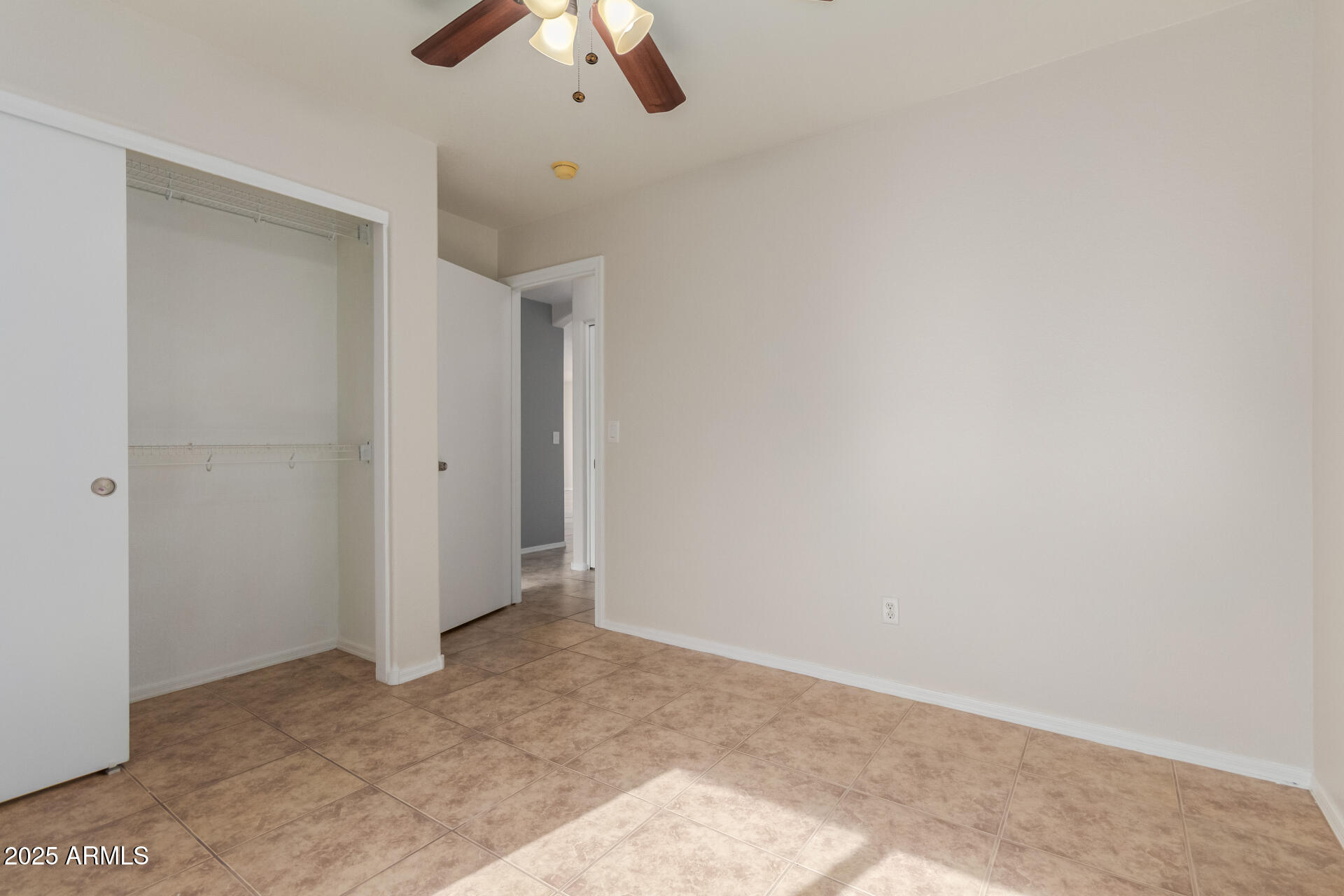 6932 South Russet Sky Way Gold Canyon, AZ 85118 - Photo 25 of 36 an empty room with a ceiling fan and carpet