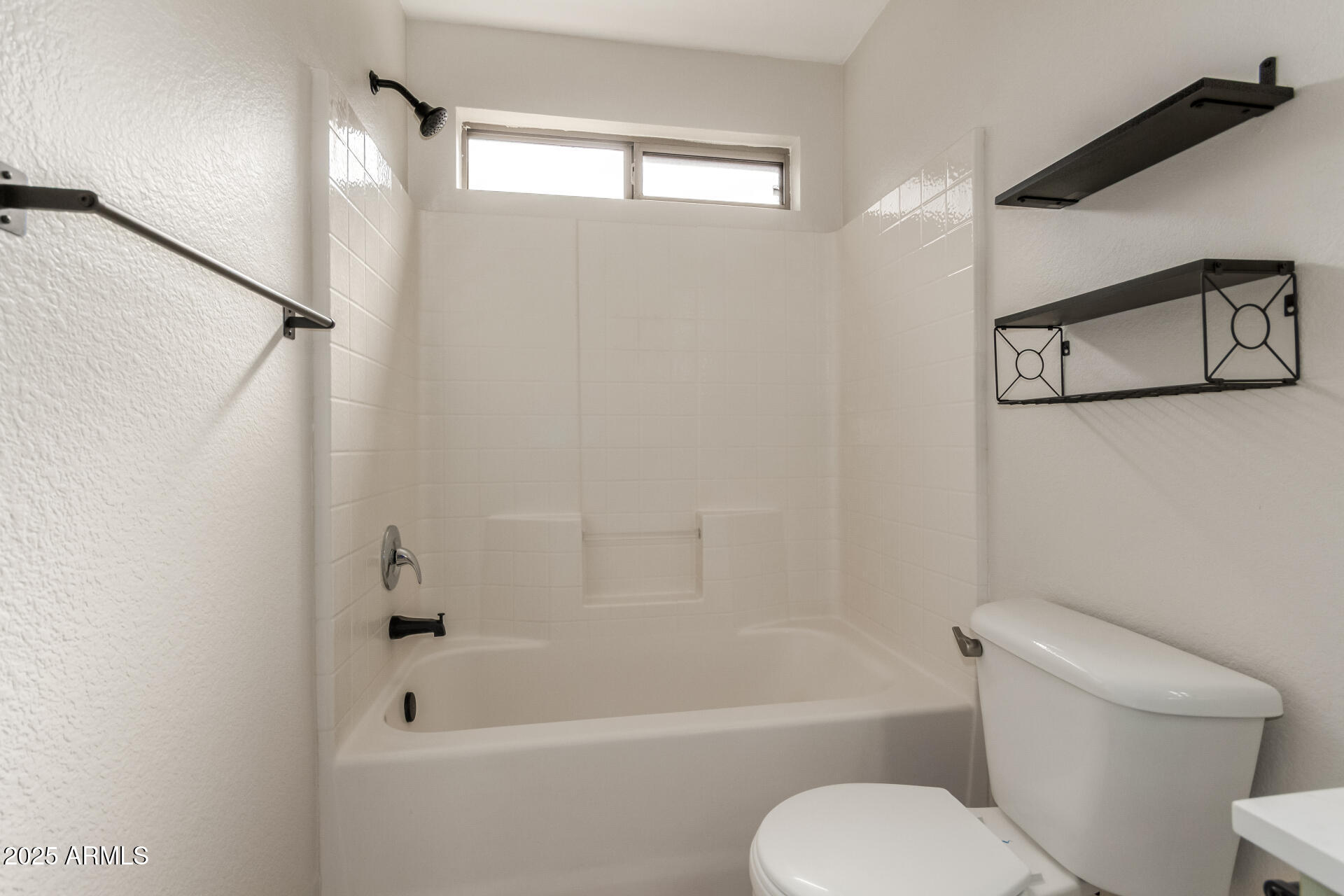 6932 South Russet Sky Way Gold Canyon, AZ 85118 - Photo 27 of 36 a white toilet and tub sitting next to a bathroom sink