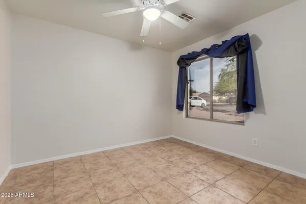 an empty room with a ceiling fan