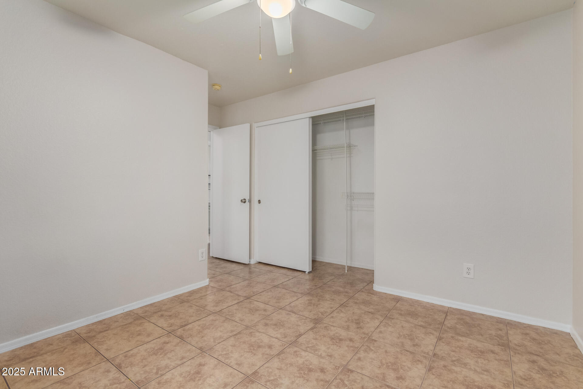 6932 South Russet Sky Way Gold Canyon, AZ 85118 - Photo 29 of 36 an empty room with a ceiling fan
