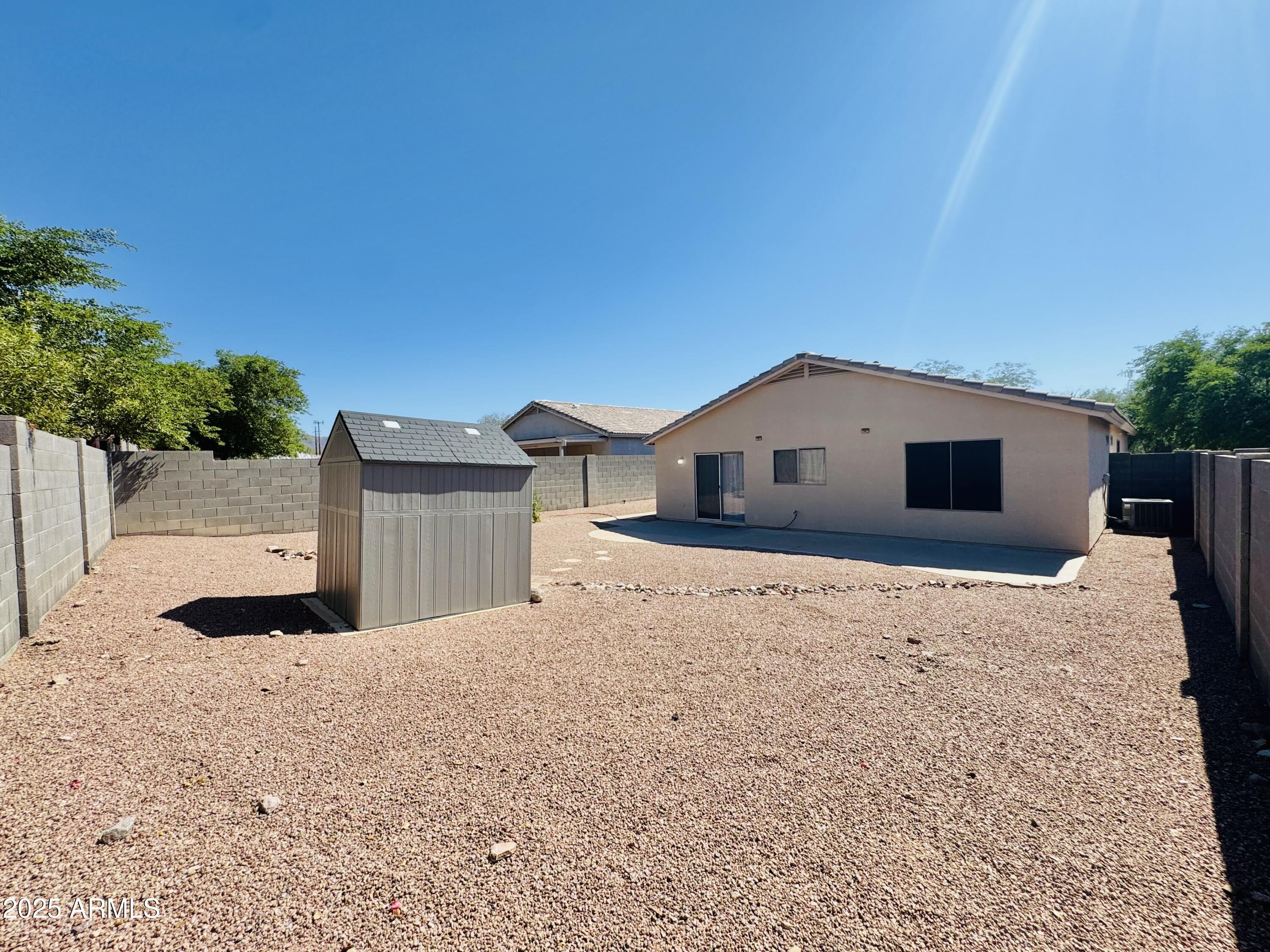 6932 South Russet Sky Way Gold Canyon, AZ 85118 - Photo 35 of 36 a house with trees in the background