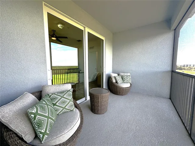 a view of a livingroom with furniture and a potted plant