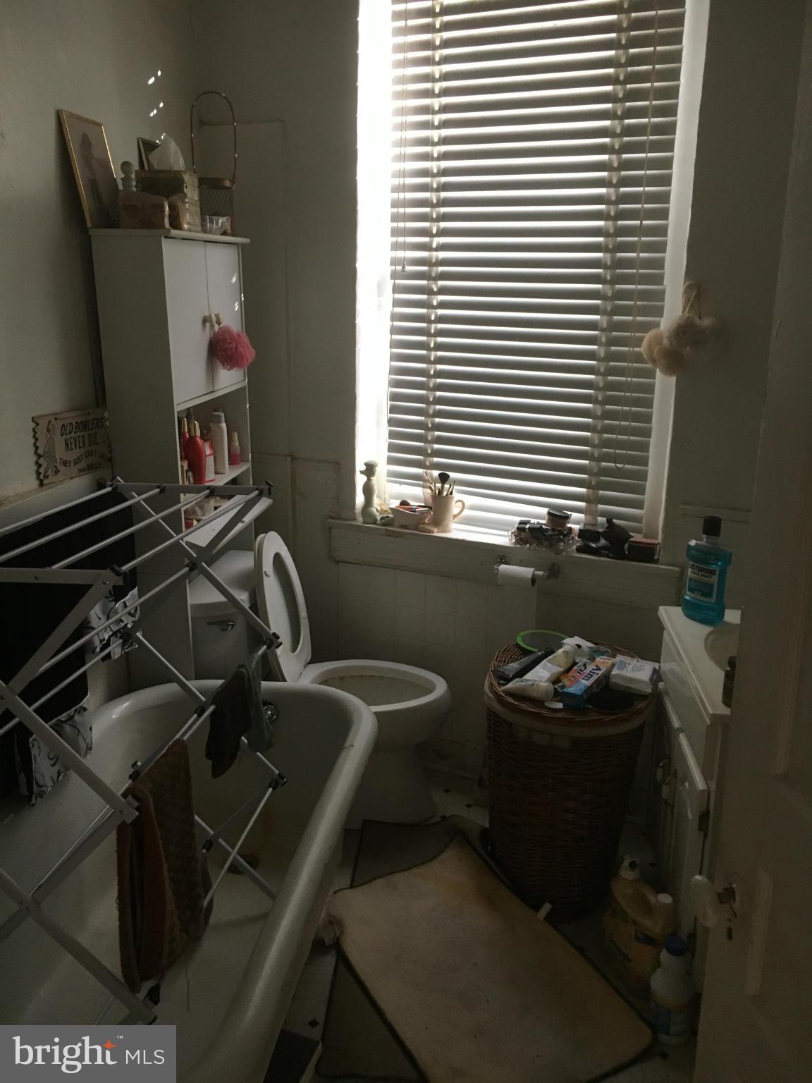 2030 Madison Avenue Baltimore, MD 21217 - Photo 12 of 24 a bathroom with a sink and a mirror