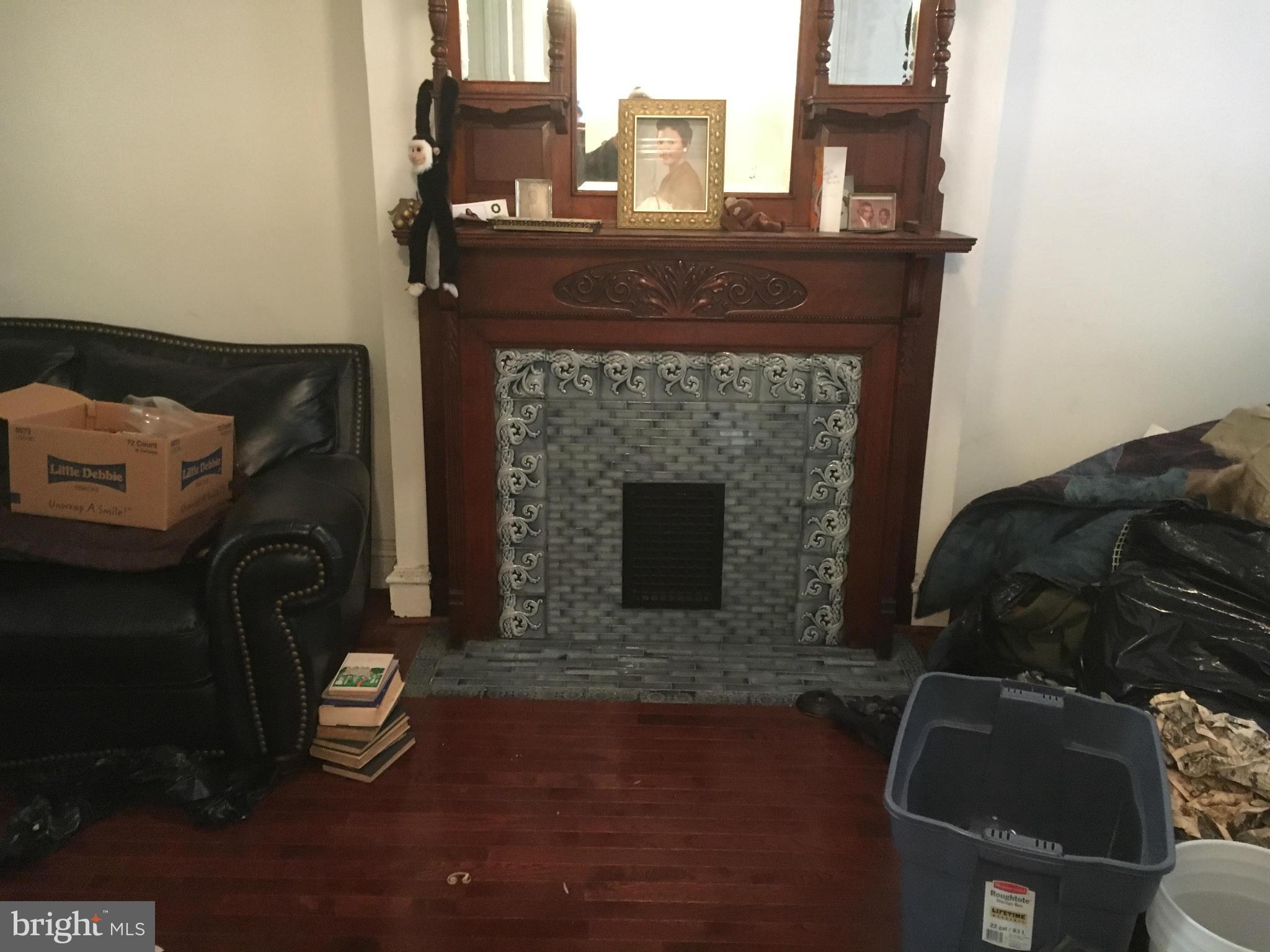 2030 Madison Avenue Baltimore, MD 21217 - Photo 3 of 24 a living room with furniture and a fireplace