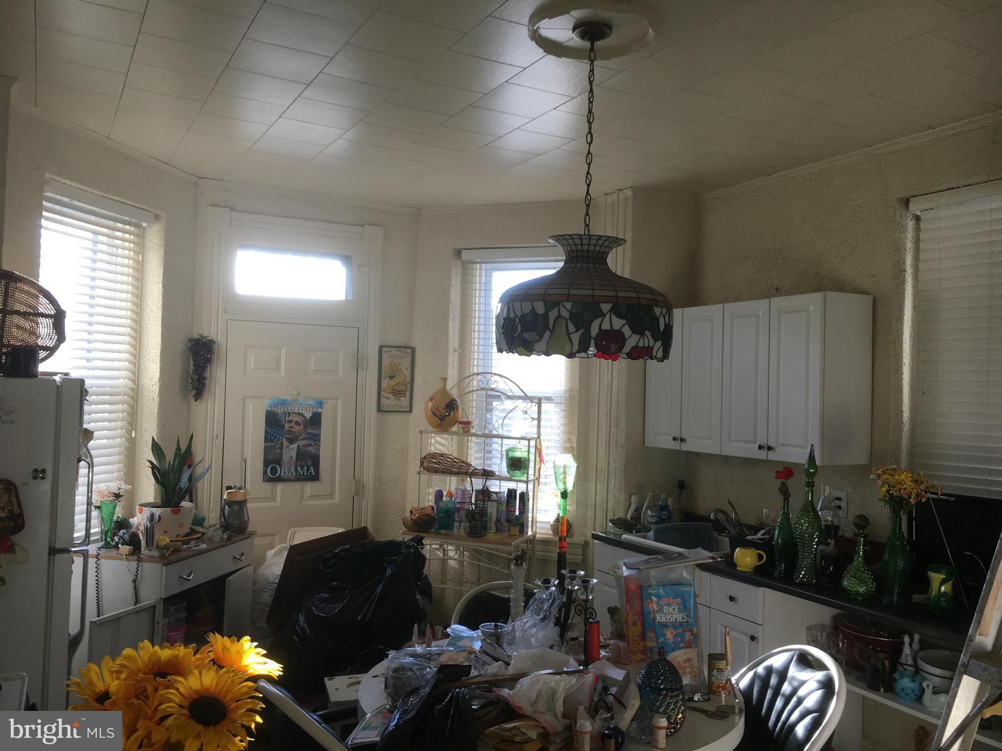 2030 Madison Avenue Baltimore, MD 21217 - Photo 6 of 24 a living room with furniture flowerpot and a chandelier