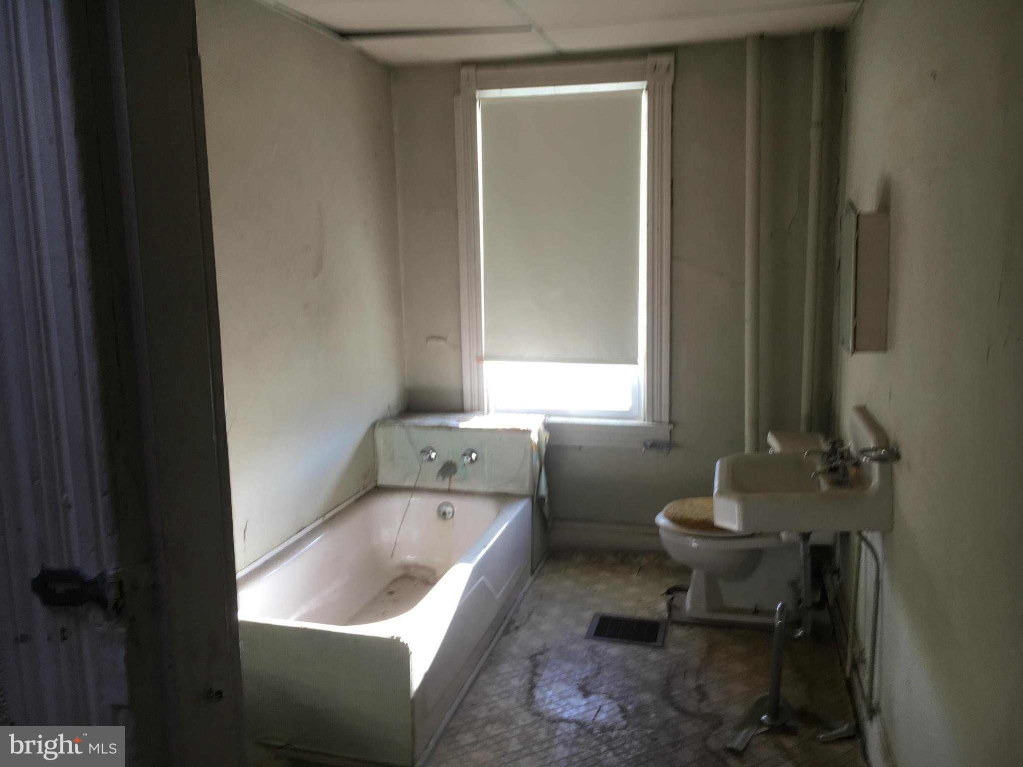 2030 Madison Avenue Baltimore, MD 21217 - Photo 7 of 24 a bathroom with a sink toilet and tub