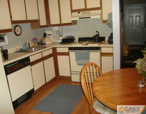 59 Renaissance Lane New Brunswick, NJ 08901 - Photo 2 of 7 a kitchen with stainless steel appliances granite countertop a stove a sink and a microwave