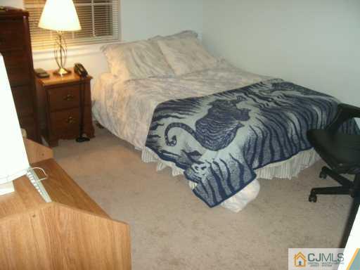 59 Renaissance Lane New Brunswick, NJ 08901 - Photo 6 of 7 a bed sitting in a bedroom next to a lamp