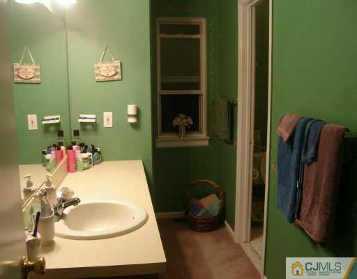 59 Renaissance Lane New Brunswick, NJ 08901 - Photo 7 of 7 a bathroom with a sink toilet and a mirror