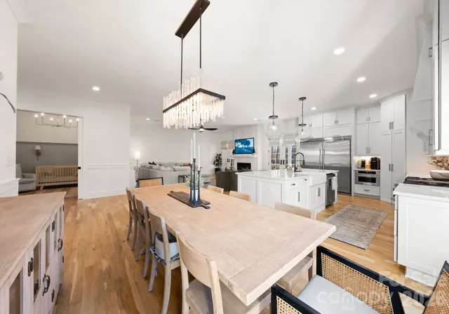 a large kitchen with a table and chairs