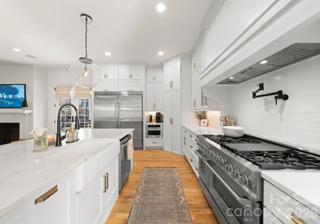 a kitchen with counter top space a sink stainless steel appliances and cabinets