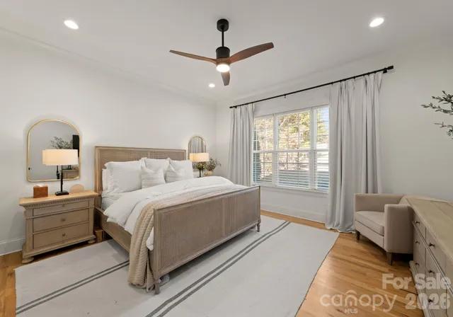 a spacious bedroom with a bed and glass door