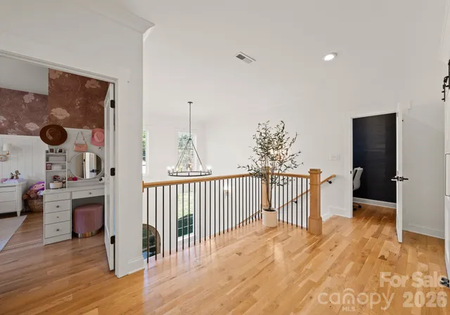 a view of a living room hardwood floor and a kitchen