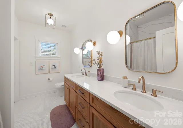 a spacious bathroom with a double vanity sink and a mirror