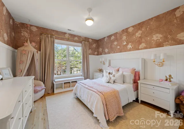 a bedroom with a bed dresser and a window