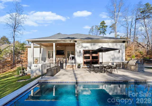 a view of a house with backyard porch and sitting area