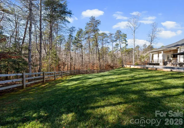 a view of a backyard with table and chairs