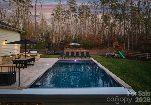 a view of a house with backyard and sitting area