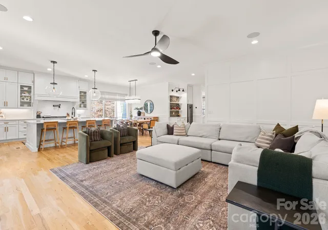 a living room with furniture kitchen and a table