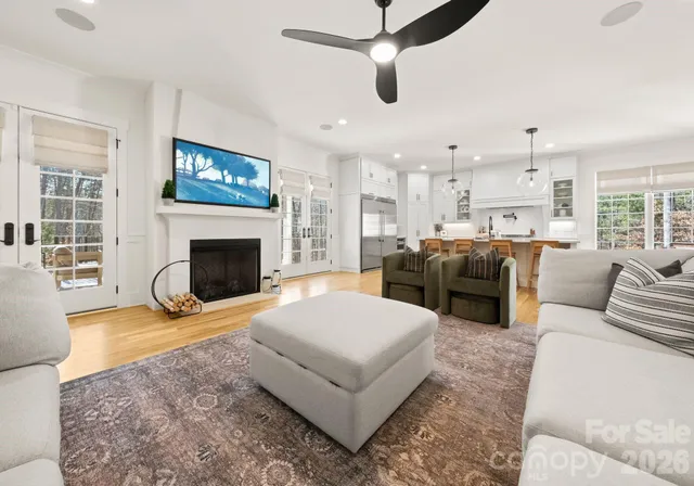 a living room with furniture a fireplace and a flat screen tv