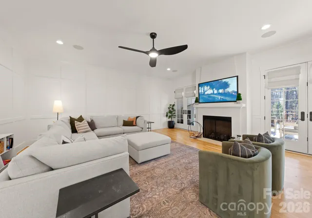 a living room with furniture a fireplace and a flat screen tv