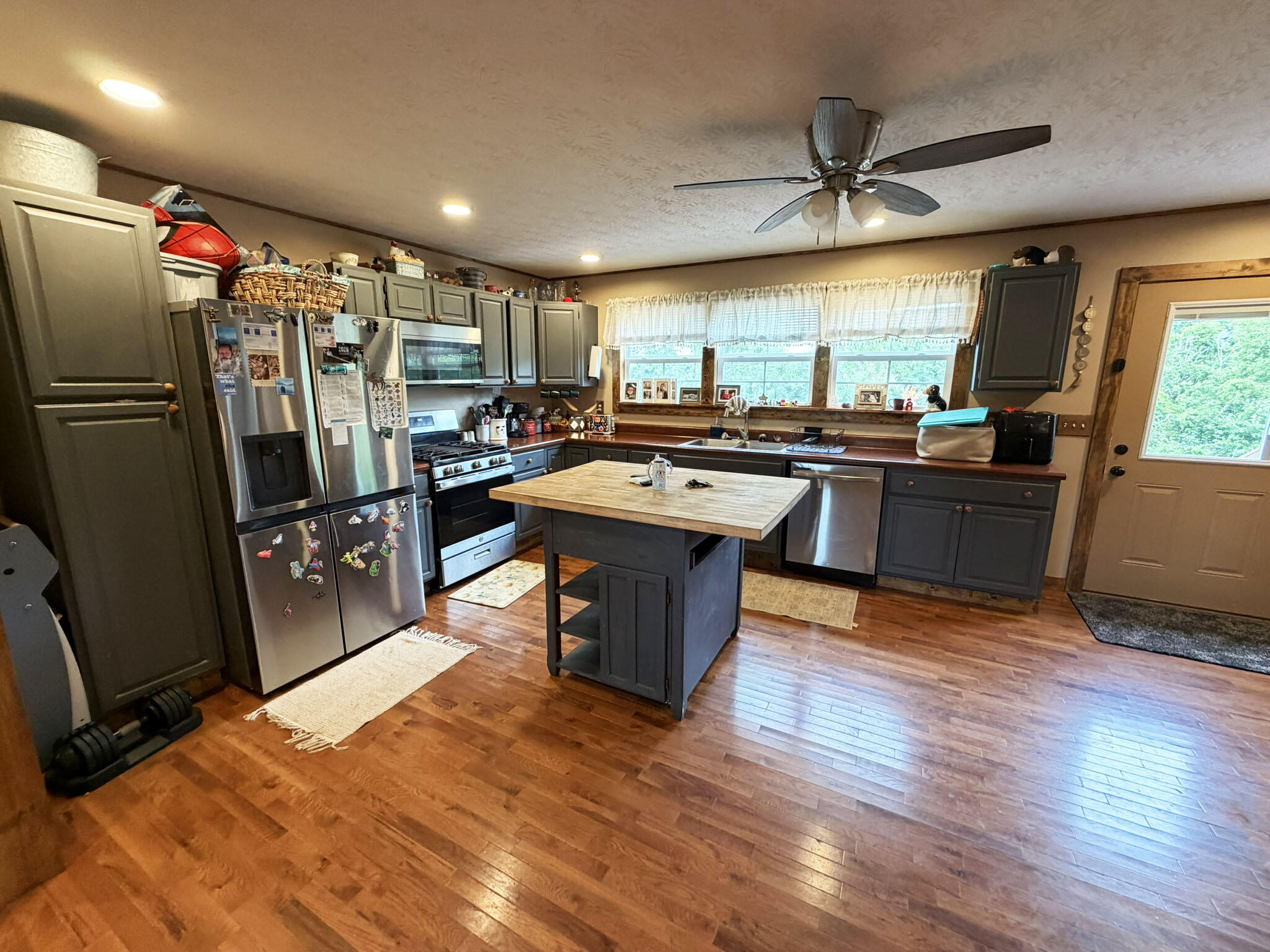 1410 Winston Road Irvine, KY 40336 - Photo 13 of 43 Spacious kitchen features abundant cabinet and countertop space, a center island, stainless steel appliances, a natural gas range, and an open layout that keeps you connected to family and guests.