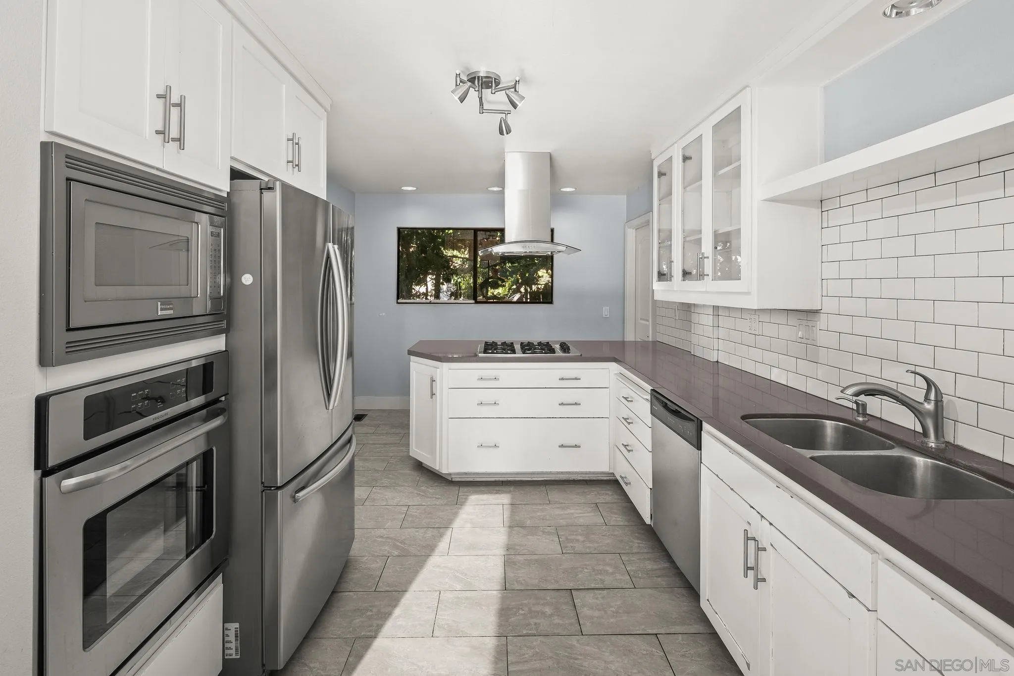 9190 Spice Street La Mesa, CA 91941 - Photo 11 of 44 a kitchen with a sink stove and refrigerator