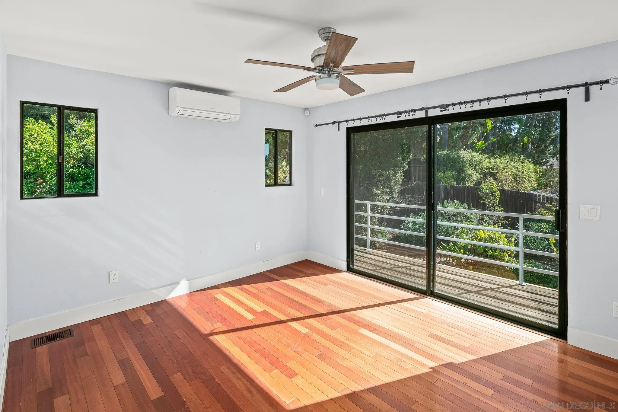 9190 Spice Street La Mesa, CA 91941 - Photo 14 of 44 a view of a room with wooden floor and a ceiling fan