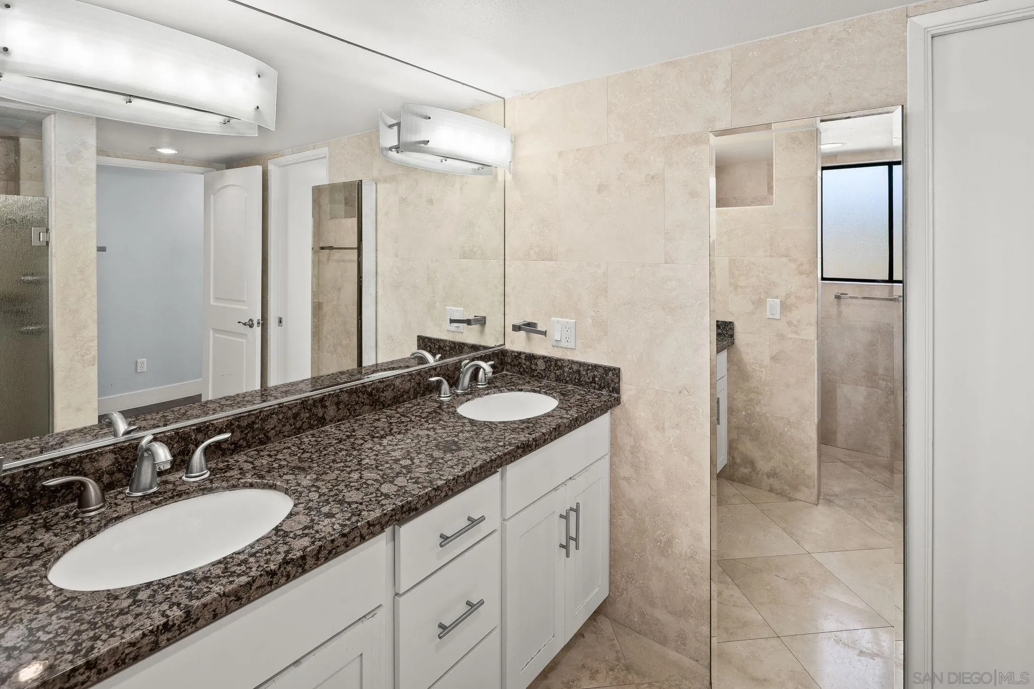 9190 Spice Street La Mesa, CA 91941 - Photo 18 of 44 a bathroom with a granite countertop double sink and a mirror
