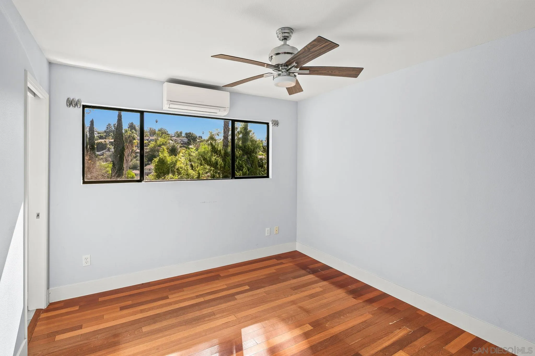 9190 Spice Street La Mesa, CA 91941 - Photo 21 of 44 a view of a big room with wooden floor fan and windows