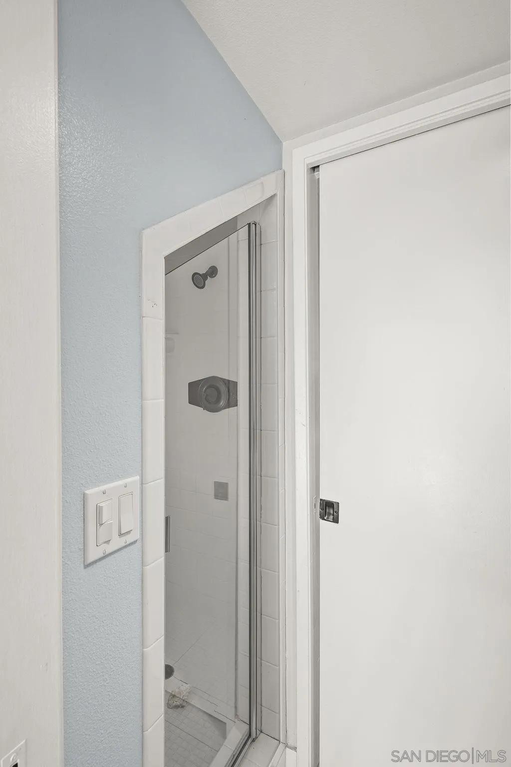 9190 Spice Street La Mesa, CA 91941 - Photo 27 of 44 a bathroom with a shower and a glass door