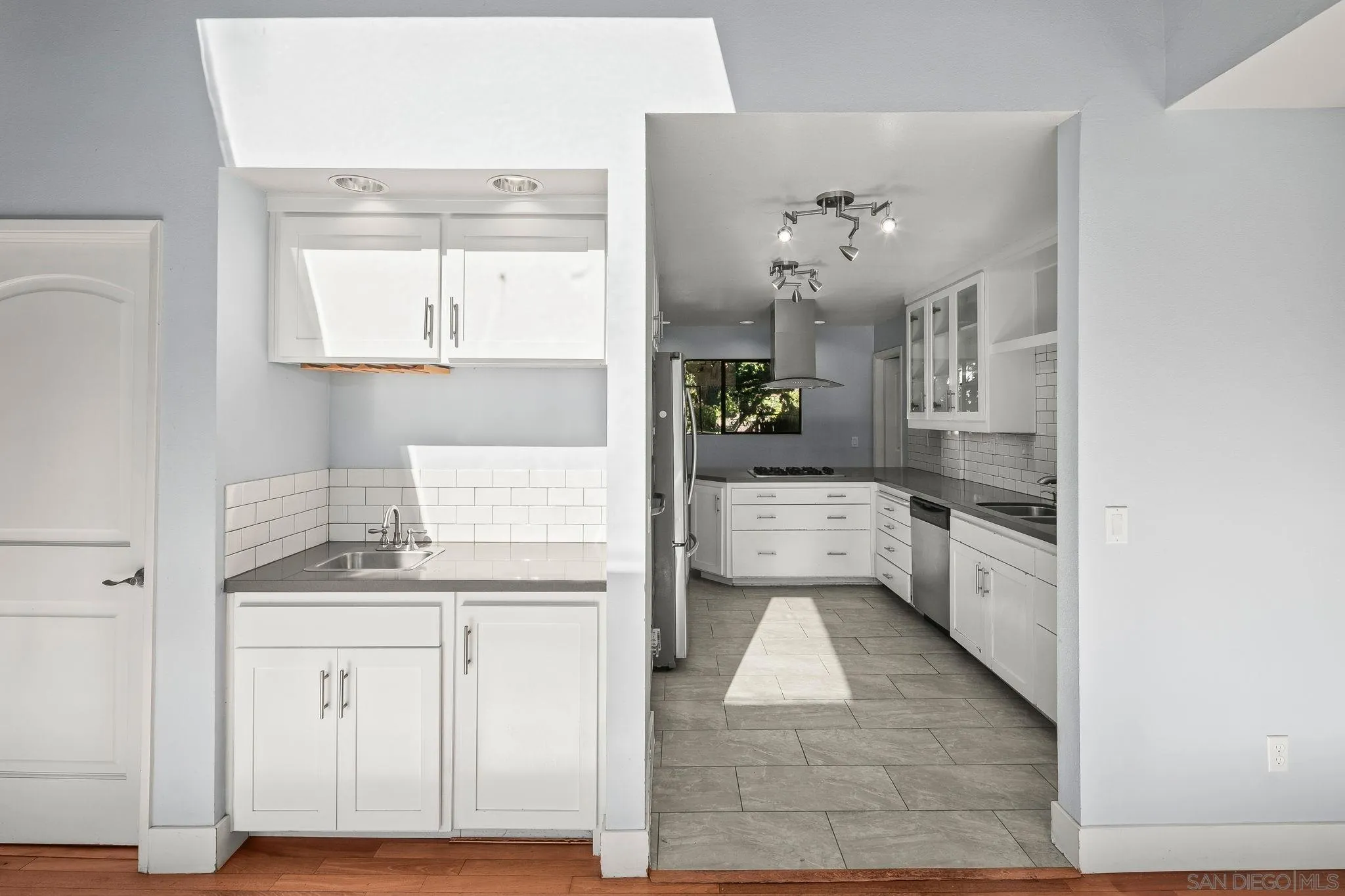 9190 Spice Street La Mesa, CA 91941 - Photo 10 of 44 a kitchen with white cabinets and appliances