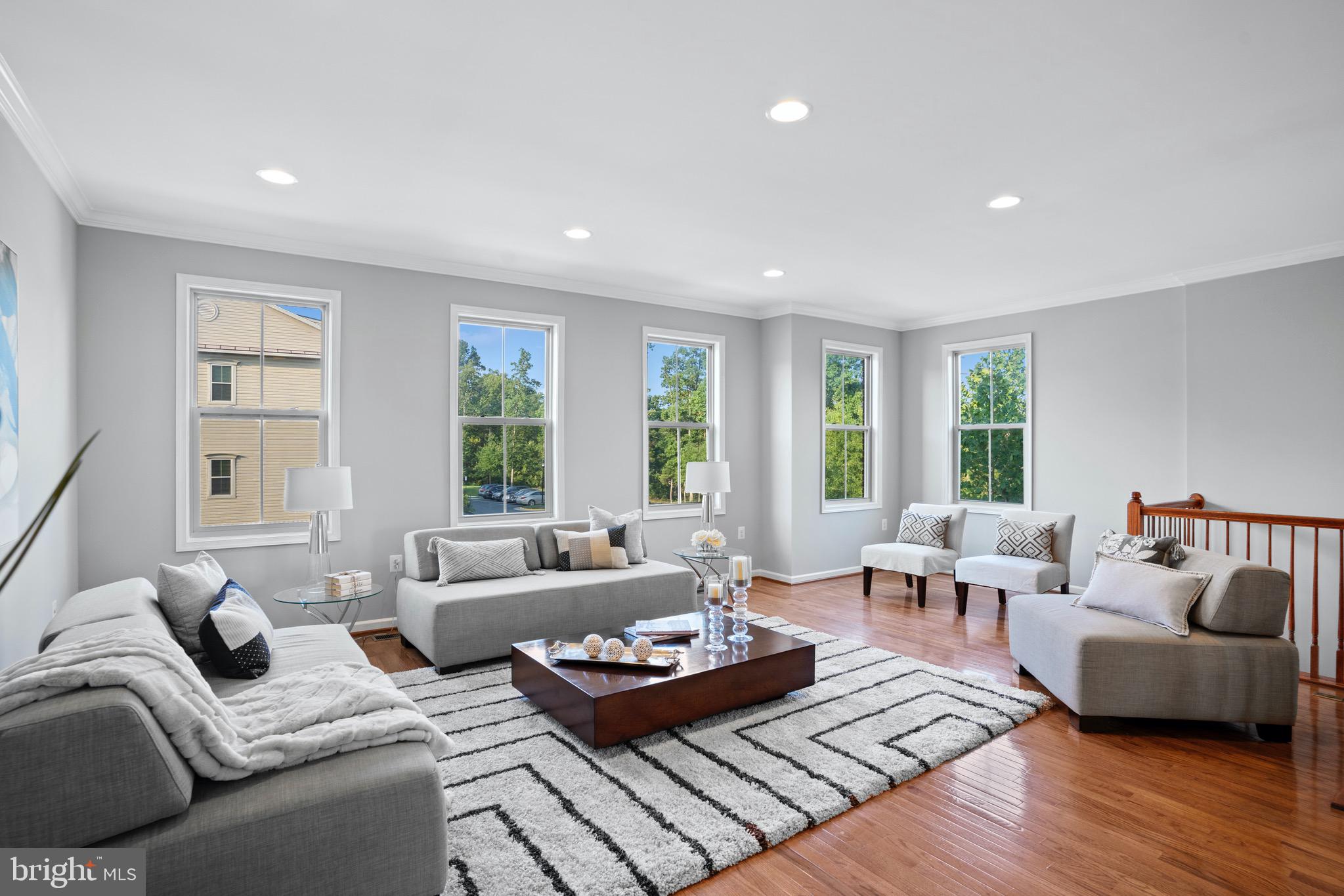 42203 Castle Ridge Square Brambleton, VA 20148 - Photo 3 of 29 Gleaming hardwood floors in the living room