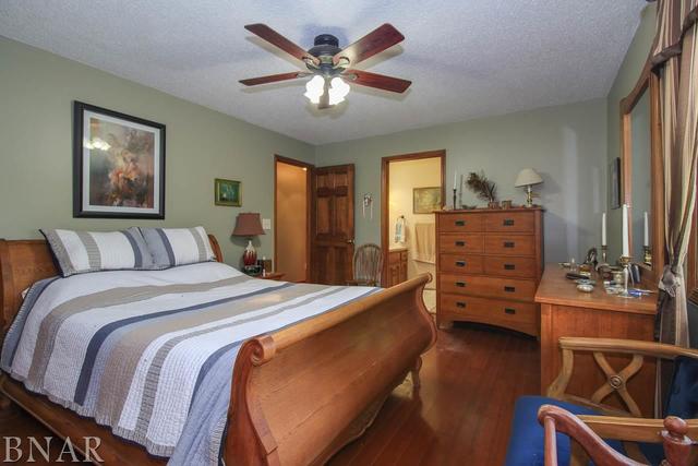 7647 White Oaks Road Clinton, IL 61727 - Photo 23 of 30 a bedroom with a bed and wooden furniture