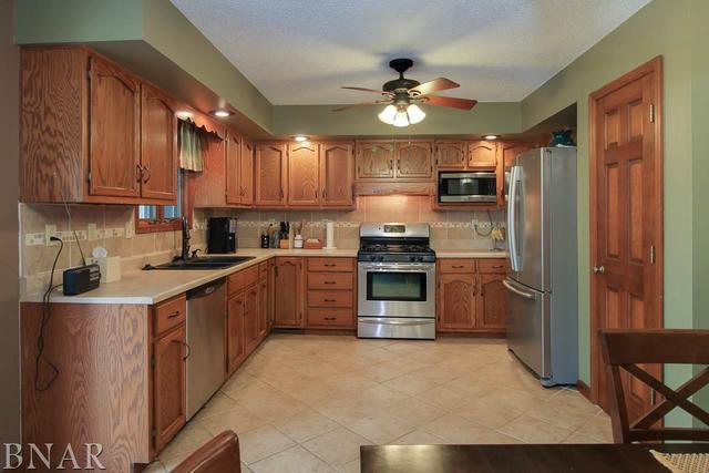 7647 White Oaks Road Clinton, IL 61727 - Photo 8 of 30 a kitchen with stainless steel appliances a refrigerator sink and stove