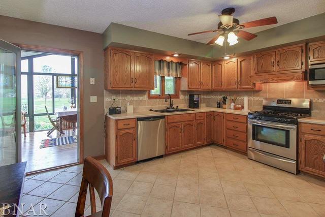 7647 White Oaks Road Clinton, IL 61727 - Photo 9 of 30 a kitchen with a sink stove and cabinets