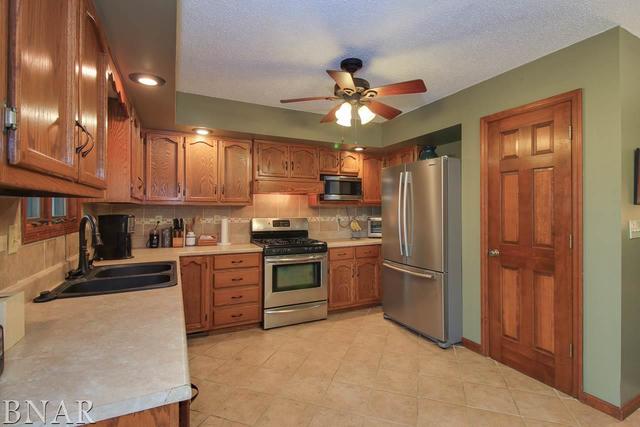 7647 White Oaks Road Clinton, IL 61727 - Photo 10 of 30 a kitchen with stainless steel appliances granite countertop a refrigerator a stove top oven a sink and dishwasher