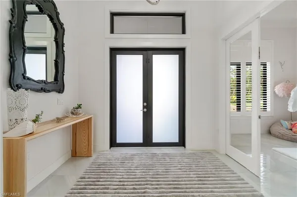 a living room with furniture and a large window with garden view
