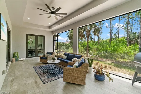 a living room with furniture and a floor to ceiling window