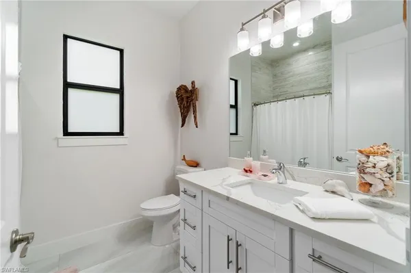 a view of walk in closet with clothes