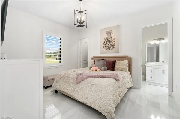 a bed room with a bed and a chandelier